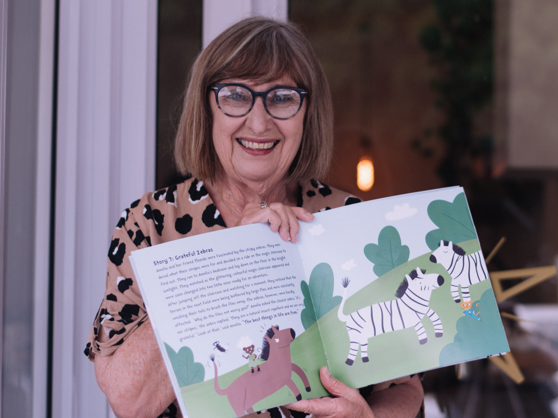 Children's book author holding her newly published children's book.