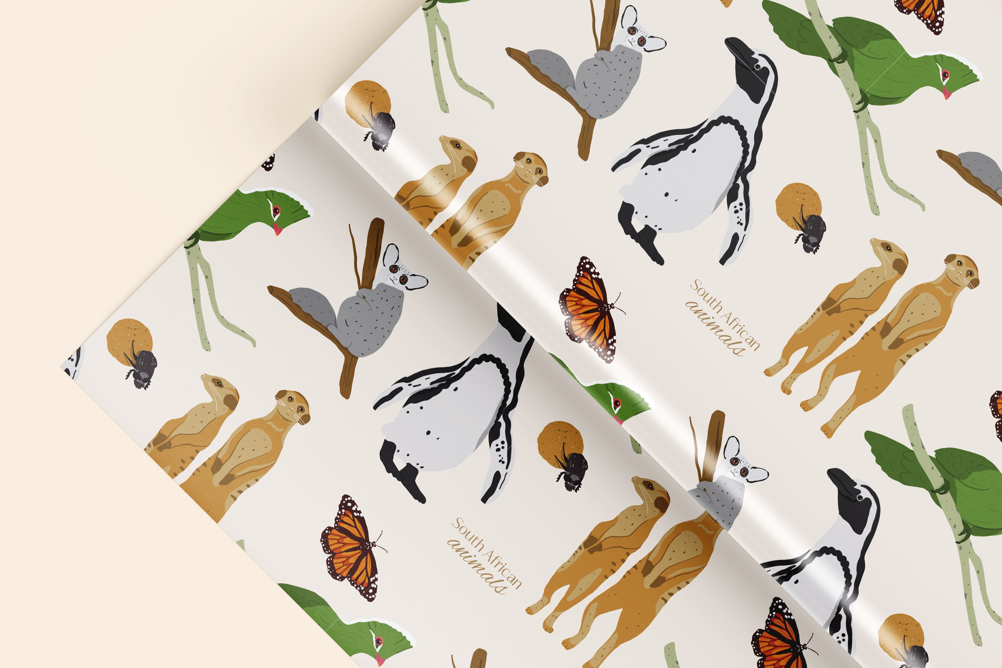 Patterned wrapping paper with illustrations of animals and plants on a beige background